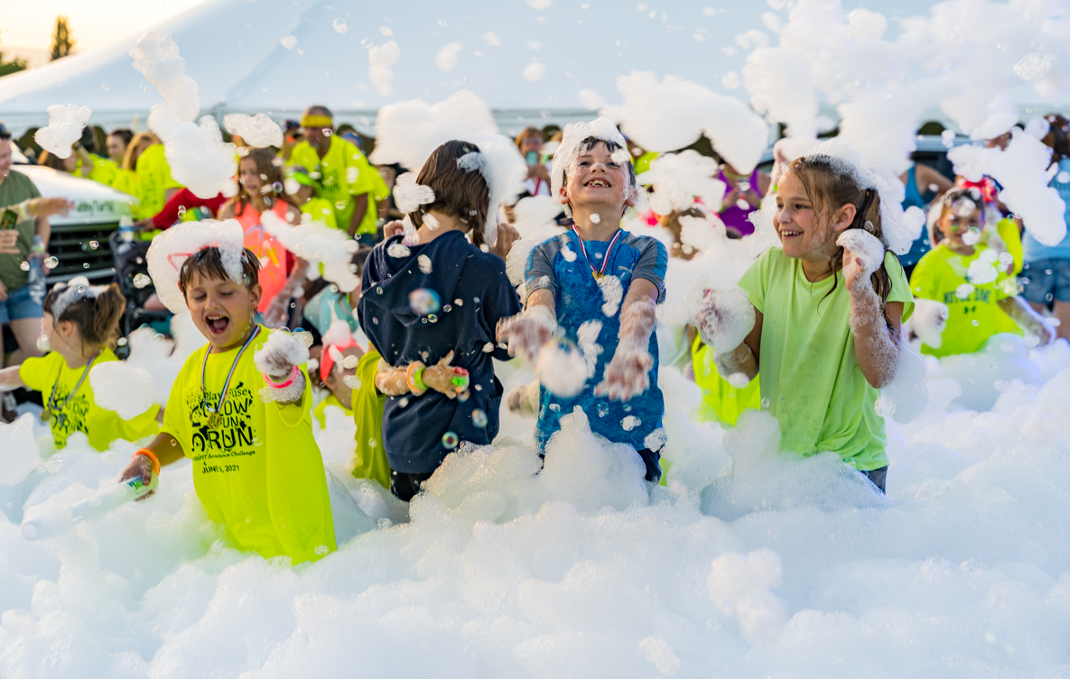 Kids running through foam at a party - Foam O Clock Party Rentals foam party rentals Boulder, CO